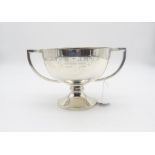 A George V silver presentation twin handled trophy cup, with twin handles and a circular capstan