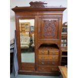 A Victorian mahogany compactum wardrobe with single mirror door to the left of cabinet door above