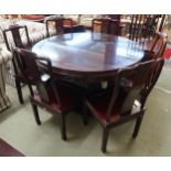 A modern Oriental style circular pedestal dining table and six accompanying oriental style dining