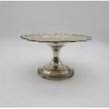 An Edwardian silver tazza, with scalloped rim, engraved to centre, by Hawksworth Eyre & Co,
