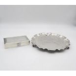 An Elizabeth II silver waiter, with a chippendale pie crust style border, support on three feet,