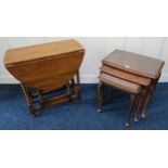 A 20th century mahogany nest of three tables and an oak drop leaf table with carved bobbin