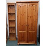 A contemporary pine two door wardrobe and a narrow pine open bookcase (2) Condition Report:Available