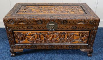A 20th century Oriental carved camphorwood blanket chest on paw feet Condition Report:Available upon