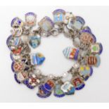 An extensive silver and enamel place name charm bracelet Condition Report:Not available for this