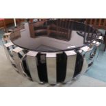 A large contemporary chrome and glass topped coffee table, 48cm high x 120cm diameter Condition