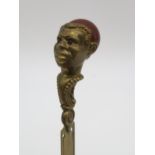 A brass work book mark, the African head set with carnellion together with a cased sewing kit,
