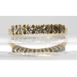An 18ct gold seven stone diamond ring, set with estimated approx 0.20cts of brilliant cut