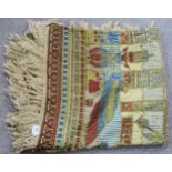 A Egyptian themed bed cover in shades of red, blue and cream with gilt thread Condition Report:Not