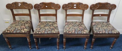 A lot of four 19th century mahogany framed sabre legged dining chairs with tapestry upholstered