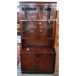 A 20th century mahogany wall unit and an Oriental style jardinière stand (2) Condition Report: