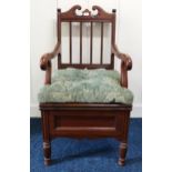 An early 20th century mahogany commode armchair with ceramic pot interior Condition Report:Available