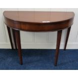 A Victorian mahogany demi lune fold over tea table on square tapering supports Condition Report: