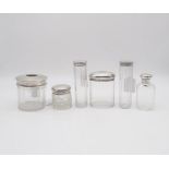 A collection of four silver topped cut glass scent bottles, most of faceted form, one by Mappin &