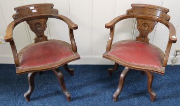 A pair of oak framed revolving ships captain chairs with red rexine seats (2) Condition Report: