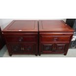 A pair of modern hardwood Oriental style lamp tables with single drawer above cabinet doors, 56cm