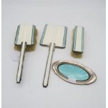 A three piece Art Deco silver, white and turquoise guilloche enamel dressing set, comprising clothes