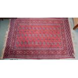 A terracotta ground Bokhara rug with all over design, 200cm long x 127cm wide Condition Report: