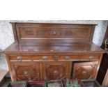 A 20th century oak sideboard with two drawers over three cabinet doors (treated previously for worm)