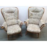 A mid 20th century Ercol elm and beech framed three piece suite consisting two seater settee and two