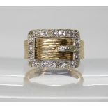 A 9ct gold diamond set buckle ring, London hallmarks for 1978, finger size H1/2, weight 5.3gms