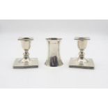 A pair of silver candlesticks, of square form, with Greek Key pattern rim, (bases weighted), by