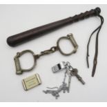 A pair of Hiatt D-Shackle handcuffs with threaded key, an Acme Thunderer Glasgow police whistle,