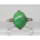 A white metal (not silver) ring set with a Chinese green hardstone, size L1/2, weight 3.3gms