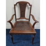 A Victorian carved oak framed open armchair and two oak framed Victorian side chairs with floral