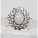 A 9ct gold cz and white opal cluster ring, size N, weight 2.6gms Condition Report:Available upon