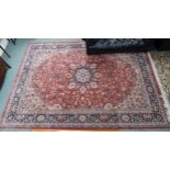 A modern terracotta ground Keshan style rug with floral central medallion, matching spandrels and