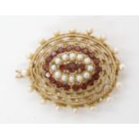 A 9ct gold garnet and pearl pendant brooch, length 4.5cm, weight 11.8gms Condition Report: