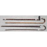 FOUR VARIOUS WALKING STICKS each with white metal mounts (4) Condition Report:Available upon