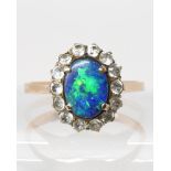 A yellow metal opal doublet and clear gem cluster ring, size Q, weight 2.4gms Condition Report: