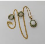 A 9ct gold opal and emerald pendant and matching earring set, weight combined 3.9gms Condition