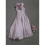 A 1950's pink and purple polka dot dress with metallic silver material shoes, pink gloves and a