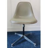 A mid 20th after Ray and Charles Eames fibreglass shell swivel chair on steel base, 80cm high x 48cm