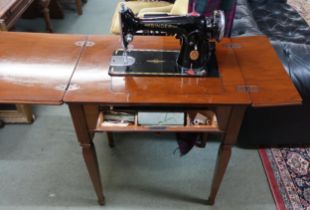 A 20th century mahogany cased Singer electric sewing machine with single drawer on square tapering
