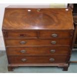 A Georgian mahogany writing bureau with fitted fall front writing compartment above two over three