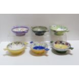 A collection of lady artist hand painted Scottish pottery quaichs, many decorated with flowers,