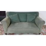 A Victorian green upholstered drop end settee on shaped mahogany feet with ceramic casters, 80cm