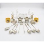 A collection of silver including a set of coffee spoons and sugar tongs with engraved floral