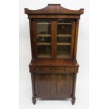 A 19TH CENTURY MAHOGANY GLAZED BOOKCASE ON CABINET BASE with two glazed doors flanked by columns