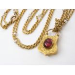 A YELLOW METAL & PEARL GUARD CHAIN WITH GARNET CLASP the bright yellow metal rope chain, is