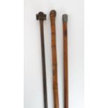 AN AFRICAN WALKING STICK the grip carved in four sections, 82cm long, a malacca cane with white