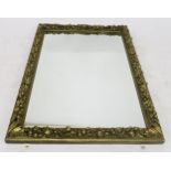 A 19TH CENTURY GILTWOOD AND GESSO RECTANGULAR WALL MIRROR with foliage and fruit decorated frame