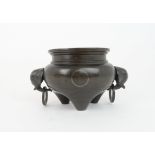 A CHINESE BRONZE CENSER with elephant and ring head handles, decorated with white metal cash on a