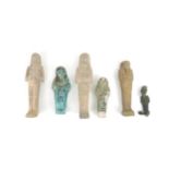 FIVE EGYPTIAN POTTERY SHABTI of traditional type mostly with hieroglyphs, 10cm, 12cm, 14cm, 15.5 and