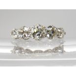 A FIVE STONE DIAMOND RING mounted in white metal with a finely made gallery, the five diamonds