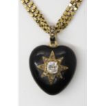 A VICTORIAN MOURNING LOCKET AND CHAIN set with an old cushion cut diamond of estimated approx 0.